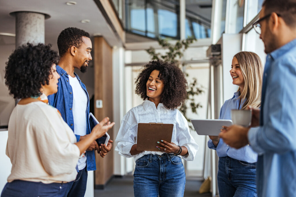 Diverse Team Discussing Ideas in a Modern Office Setting - WorldTone